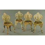 A set of four Victorian cast iron garden chairs,