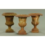 A set of three 19th century cast iron miniature garden urns,