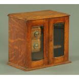 An Edwardian oak smokers tabletop cabinet,