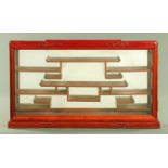 A Chinese hardwood collectors cabinet, with mirrored back and single door, width 86 cm,