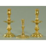 A pair of early 18th century brass candlesticks,