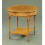 An Edwardian mahogany centre table, circular and inlaid with bellflower and scrolls,