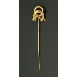 A gold coloured metal stick pin with horseshoe terminal, in fitted plush lined case, 8.2 cm.