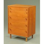 A Meredew teak chest of five drawers, supported upon tuned circular legs.