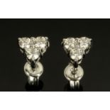 A pair of 18 ct white gold trefoil diamond set stud earrings, total diamond weight +/- .54 carats.