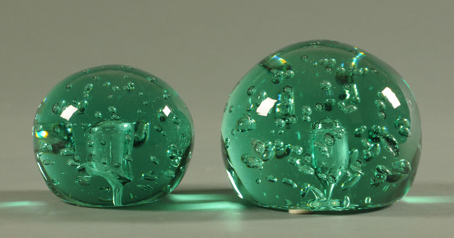 Two large Victorian green glass dumps, dome form, decorated with interior bubbles. Heights 13.