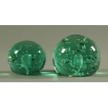 Two large Victorian green glass dumps, dome form, decorated with interior bubbles. Heights 13.