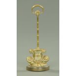 A Victorian brass doorstop, cast iron weighted, height 39 cm.