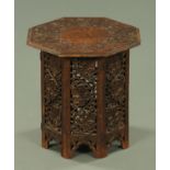 An Eastern carved wooden octagonal occasional table, fruiting vine decoration, width 38 cm.