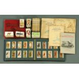 A collection of cigarette card albums and loose cigarette cards,