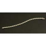 An 18 ct white gold diamond set tennis bracelet, total diamond weight +/- 4.