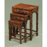 A quartetto of Chinese hardwood occasional tables, each with foliate carved edge and pierced frieze,