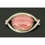 A polished hardstone brooch within a white metal mount, struck "950" (platinum),