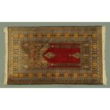 An Eastern prayer rug, silky pile, with fringed ends,