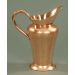 A large 19th century polished copper jug, with inverted baluster body upon a raised circular foot,