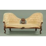 A Victorian walnut framed double chair back settee,