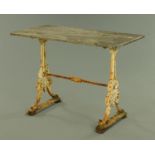 A Victorian cast iron garden table with rectangular polished slate top with canted corners,