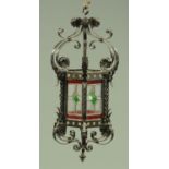 A vintage wrought iron and glass hall lantern, with ceiling hook, height excluding hook 68 cm,