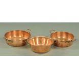 Three 19th century copper two handled cans, largest diameter 42 cm.