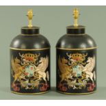 A pair of tole ware style table lamps, each engraved with a coat of arms,