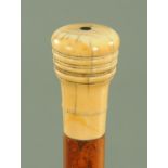 A George III malacca walking cane, with turned ivory grip with inlaid ebony centre,