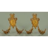 A pair of 19th century metal tie backs, each with classical cameo, height 26 cm, width 23 cm.