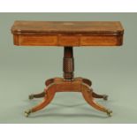 A Regency rosewood turnover top games table, with tooled leather playing surface,