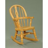 A Victorian style oak child's Windsor rocking chair, width across arms 43 cm,