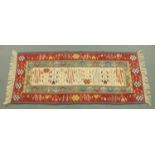 An Eastern fringed runner, with centre beige panel and fringed ends. 200 cm x 88 cm.