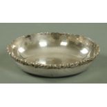 A South American silver shallow bowl, early 20th century, with applied scrolling rim,