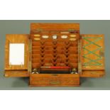 A late Victorian stationery cabinet, by Parkins & Gotto, Oxford Street, with month and date cards,