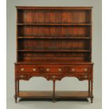 A 19th century Shropshire style oak dresser with rack,