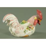 An Italian tin glazed cockerel, with handpainted floral decoration,