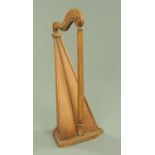 A 19th century harp, the shaped top rail with applied wood rosette,