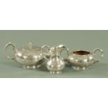 A Victorian silver plated three piece tea set with engraved decoration and initialled W,