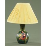 A Moorcroft orchid pattern table lamp, early/mid 20th century, of bottle form,