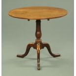 A George III mahogany tripod table, circular, with snap action,