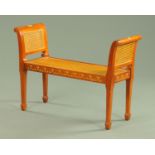 A Sheraton style painted mahogany and bergere window seat, with loose cushion.