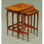 A nest of three walnut tables, each raised on shaped legs terminating in pad feet, width 47.5 cm.