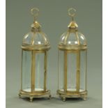 A pair of metal and glass lanterns, each with single door and carrying handle, height 80 cm.