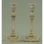 A pair of Adam style silver plated candlesticks, square form, with detachable sconces.