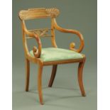 A Regency mahogany armchair, with carved bowed top rail,