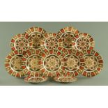 Royal Crown Derby, seven 26.5 cm Imari patterned plates and five 21.5 cm Imari patterned plates.