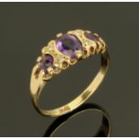 A 9 ct gold dress ring, set with three amethyst coloured stones, size O.