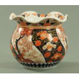 A Japanese Imari jardiniere, late Meiji period, having a wavy rim above panels of wisteria,