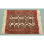 An Afghan rug. 122 cm x 180 cm including fringe.