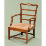 A George III provincial armchair with pierced ladder back,