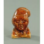 A treacle glazed novelty Soutar Johnny money box, 19th century, possibly Dunmore Pottery Scotland,