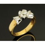 An 18 ct two tone gold bow ring set with diamonds, total diamond weight +/ .65 carats, size N.