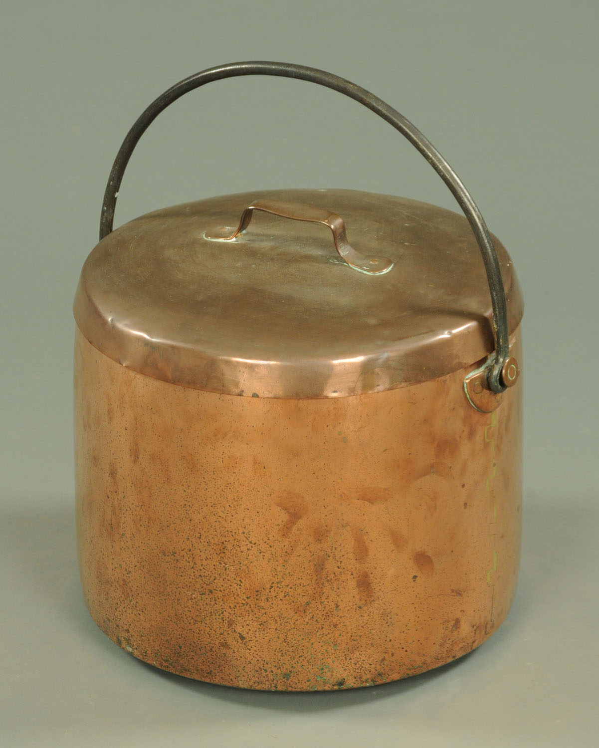 A large 19th century copper lidded vessel, with iron loop handle, diameter 40 cm.